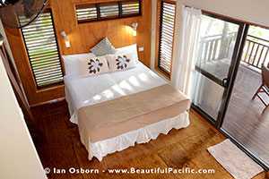 king bed of beachfront villa as seen from mezzanine